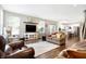 Stylish living area flows into the kitchen, featuring hardwood floors and neutral decor at 7251 Birch Leaf Dr, Indianapolis, IN 46259