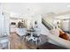 Bright open-concept living space with modern kitchen, dining area, staircase, and comfortable seating at 7251 Birch Leaf Dr, Indianapolis, IN 46259