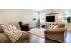 Bright and airy living room offering ample seating, hardwood floors, and natural light at 7251 Birch Leaf Dr, Indianapolis, IN 46259