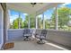 Charming screened-in porch with comfortable seating and serene backyard views at 7251 Birch Leaf Dr, Indianapolis, IN 46259