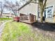 A serene backyard with a wooden deck and lush greenery creates a private oasis at 8030 Windham Lake Way, Indianapolis, IN 46214