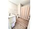 Clean bathroom with modern flooring, toilet, shower with tan curtain, and vanity at 8030 Windham Lake Way, Indianapolis, IN 46214
