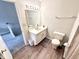 Bright bathroom features a vanity with drawers, framed mirror, and updated commode at 8030 Windham Lake Way, Indianapolis, IN 46214