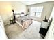 Comfortable bedroom featuring carpeted floors, natural light, and closet space at 8030 Windham Lake Way, Indianapolis, IN 46214