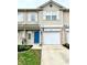Charming townhome with a blue front door, a one car garage, and manicured landscaping at 8030 Windham Lake Way, Indianapolis, IN 46214