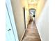 Bright hallway with wood floors leading to stairs and living area at 8030 Windham Lake Way, Indianapolis, IN 46214