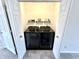 Convenient laundry closet with stacked washer and dryer units and shelving at 8030 Windham Lake Way, Indianapolis, IN 46214