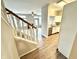 Open concept living area with a staircase view and a kitchen bar at 8030 Windham Lake Way, Indianapolis, IN 46214