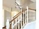 Open staircase with wooden handrail and white spindles leading to the upper level at 8030 Windham Lake Way, Indianapolis, IN 46214