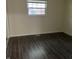 Comfortable bedroom with a window that provides natural light and sleek hardwood floors at 8345 Paso Del Norte Ct, Indianapolis, IN 46227