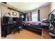 This bedroom features a computer desk, window, queen sized bed, and carpeted floor at 839 Bough St, Whiteland, IN 46184