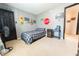 Cozy bedroom features a checkered bedspread, carpeted floor, painted walls, and playful decor at 839 Bough St, Whiteland, IN 46184