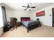 Bright bedroom with neutral walls, ceiling fan, and large bed at 839 Bough St, Whiteland, IN 46184
