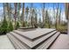 Multi-tiered deck with a hot tub and comfortable seating overlooking a serene setting at 8990 Pickwick Dr, Indianapolis, IN 46260