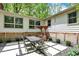 Cozy patio with dining set, decorative planters, and patterned stonework creating a charming outdoor retreat at 8990 Pickwick Dr, Indianapolis, IN 46260