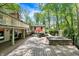Inviting outdoor space with a spacious patio, hot tub, and comfortable seating nestled among trees at 8990 Pickwick Dr, Indianapolis, IN 46260