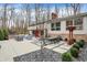 Inviting backyard with a patio, dining set, and lush landscaping for outdoor entertaining at 8990 Pickwick Dr, Indianapolis, IN 46260