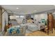 Basement living area features a comfortable sectional, bookshelves, and ample space for recreation at 8990 Pickwick Dr, Indianapolis, IN 46260