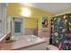 Bathroom boasting a colorful shower curtain and complementary pink tile, featuring a mirrored vanity at 8990 Pickwick Dr, Indianapolis, IN 46260