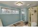 Clean bathroom with window, shower, and simple fixtures at 8990 Pickwick Dr, Indianapolis, IN 46260