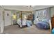 Charming bedroom with a four-poster bed, bright windows, and a cozy beanbag chair at 8990 Pickwick Dr, Indianapolis, IN 46260