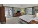 Spacious bedroom featuring neutral carpet, french doors, and many windows for natural light at 8990 Pickwick Dr, Indianapolis, IN 46260