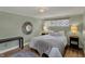 Comfortable bedroom with decorative mirror, comfortable bed, and warm ambient lighting at 8990 Pickwick Dr, Indianapolis, IN 46260