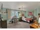 Bright bedroom with a large window, a work desk, and decor elements that personalize the space at 8990 Pickwick Dr, Indianapolis, IN 46260
