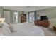 Large bedroom features neutral carpet, light green paint, and access to the outdoor patio at 8990 Pickwick Dr, Indianapolis, IN 46260