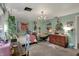 Charming bedroom featuring natural light, cozy reading nook, and vintage-inspired décor at 8990 Pickwick Dr, Indianapolis, IN 46260