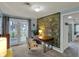 Bedroom with a desk, light blue walls, and access to a balcony at 8990 Pickwick Dr, Indianapolis, IN 46260