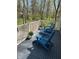 Inviting deck with blue Adirondack chairs, perfect for enjoying the surrounding trees and sunny weather at 8990 Pickwick Dr, Indianapolis, IN 46260