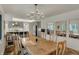 Open concept dining room featuring hardwood floors and a view into the kitchen with breakfast bar at 8990 Pickwick Dr, Indianapolis, IN 46260