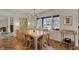 Light-filled dining room featuring hardwood floors, modern lighting, and a large window with backyard views at 8990 Pickwick Dr, Indianapolis, IN 46260