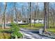 Beautiful single-story home surrounded by mature trees and meticulously maintained landscaping at 8990 Pickwick Dr, Indianapolis, IN 46260