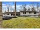Traditional ranch home with a well-manicured lawn and mature trees offering great curb appeal at 8990 Pickwick Dr, Indianapolis, IN 46260