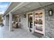 Inviting front porch featuring stone accents and comfortable seating area at 8990 Pickwick Dr, Indianapolis, IN 46260