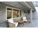 Cozy front porch with stone facade and stylish outdoor furniture at 8990 Pickwick Dr, Indianapolis, IN 46260