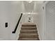 Hallway with carpeted stairs and white walls at 8990 Pickwick Dr, Indianapolis, IN 46260
