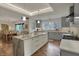 Open kitchen featuring a large island with seating, stainless steel appliances, and an adjacent dining room at 8990 Pickwick Dr, Indianapolis, IN 46260