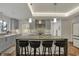 Modern kitchen featuring a large island with seating, stainless steel appliances, and stylish pendant lights at 8990 Pickwick Dr, Indianapolis, IN 46260