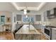 Bright kitchen with a large island, modern stainless steel appliances, and sleek gray cabinetry at 8990 Pickwick Dr, Indianapolis, IN 46260