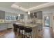Modern kitchen featuring a large island with barstool seating, stainless steel appliances, and light-filled windows at 8990 Pickwick Dr, Indianapolis, IN 46260