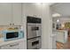 Modern kitchen features stainless steel oven appliances and bright blue microwave at 8990 Pickwick Dr, Indianapolis, IN 46260