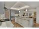 Open concept kitchen featuring a large island, stainless steel appliances, and seamless flow to the dining area at 8990 Pickwick Dr, Indianapolis, IN 46260