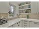 Bright kitchen features white countertops, modern appliances, and a window overlooking the outdoors at 8990 Pickwick Dr, Indianapolis, IN 46260