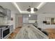 Spacious kitchen with a large center island featuring barstool seating and modern appliances at 8990 Pickwick Dr, Indianapolis, IN 46260