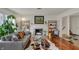 Bright living room features large windows, hardwood floors, and a fireplace at 8990 Pickwick Dr, Indianapolis, IN 46260