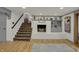 Inviting living room features a fireplace with decorative mantel and charming staircase at 8990 Pickwick Dr, Indianapolis, IN 46260