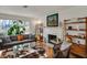 Cozy living room with fireplace, hardwood floors, and large window at 8990 Pickwick Dr, Indianapolis, IN 46260